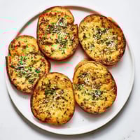 Golden-brown Cloud Bread Savory Toast topped with fresh chives and parsley, ready for dipping.