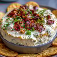 Creamy Cinco de Mayo Loaded Queso Dip with spicy chorizo and fresh pico de gallo, served with crunchy tortilla chips.  