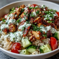 Juicy Middle Eastern Shawarma Bowl piled high with vibrant veggies and creamy sauce.